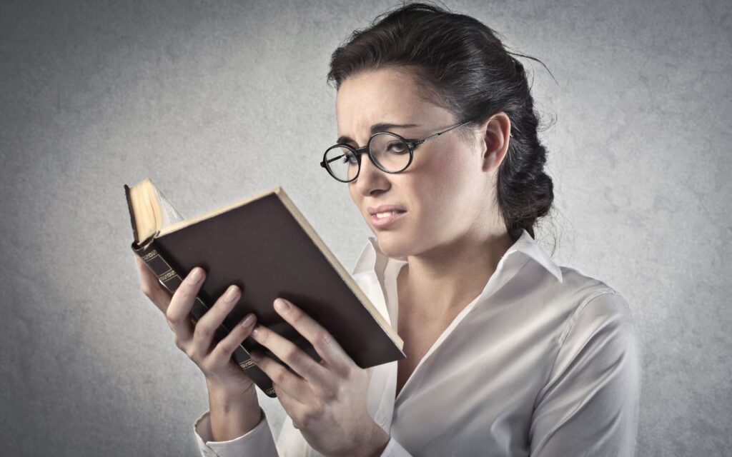 woman reading a bad book, looking unhappy