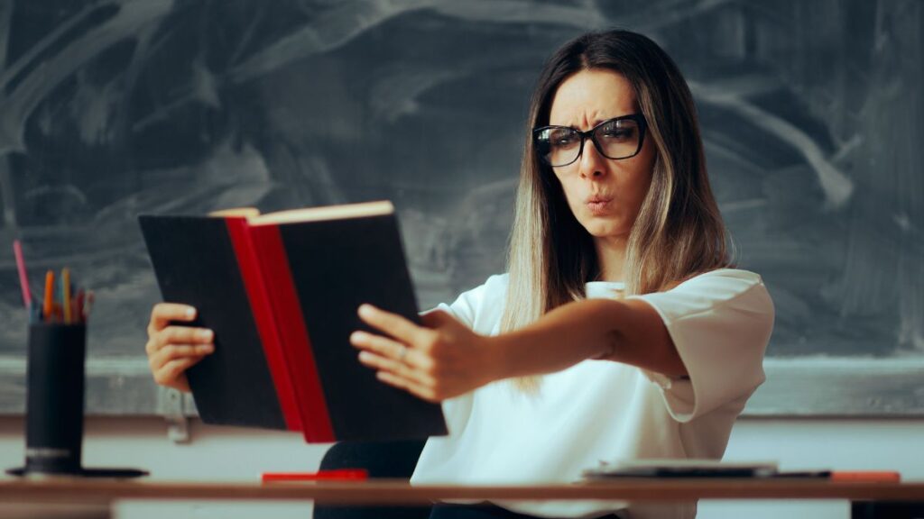 woman reading a book looking confused