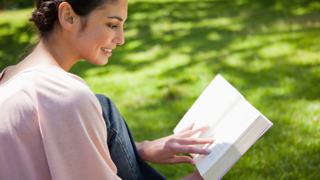 woman reading a book outside