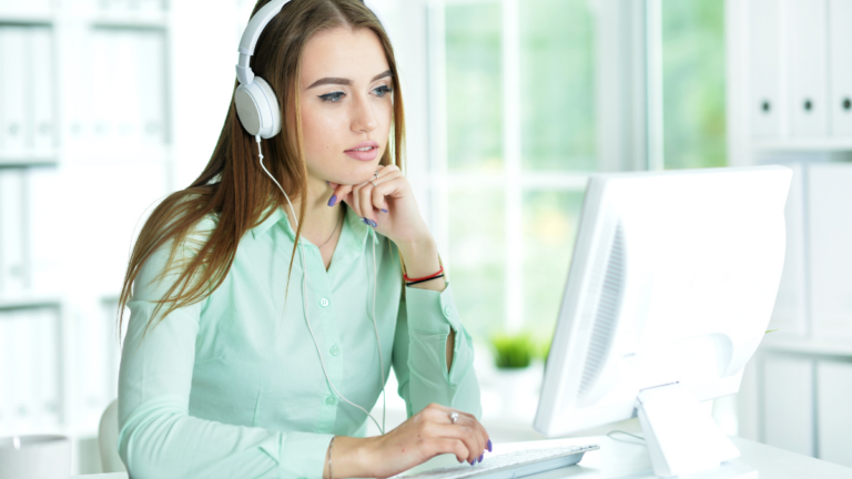 woman working at computer with headphones